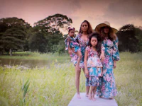 beyonce and her daughters pose for a photo in a field