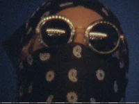 a person wearing a bandana and sunglasses