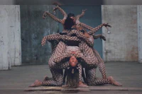 a group of dancers posing on top of each other