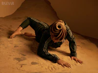 a woman laying on the ground in a sand pit